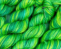a close up of green and yellow skeins
